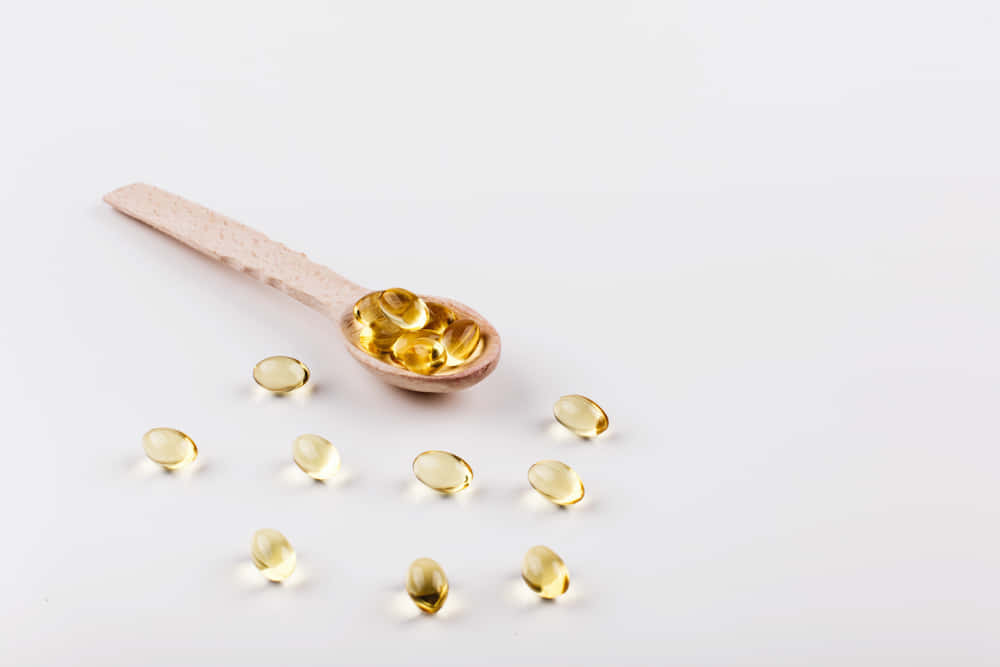 Qué es el omega 3 - Cuchara con pastillas de omega 3